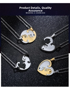 Detail of interlocking heart and round cat pendants with black and white enamel finish