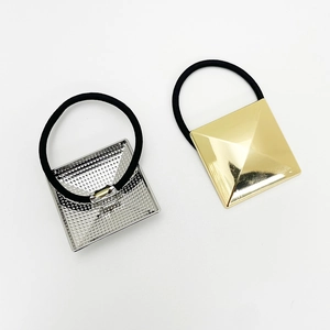 Detail of high-elasticity hair ties with gold and silver pyramid alloy accents
