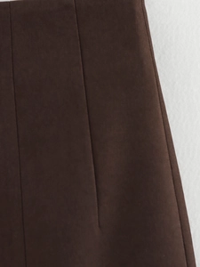 Detail of dark brown twill fabric texture with visible stitching on women suit set