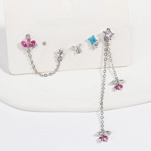 Detail of four-piece earring set with pink and blue zircons on jewelry card