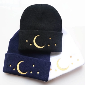 Winter knitted beanie with gold moon and star embroidery in black, navy, and white