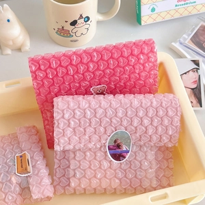 Pink heart-shaped bubble wrap packaging for protecting small cards and gift items