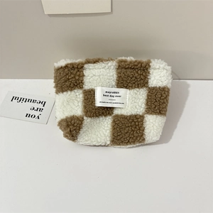 Detail of checkered plush storage bag with soft texture and minimalist woven label