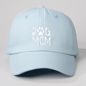 Close-up detail of DOG MOM text and paw print on light blue cotton baseball cap