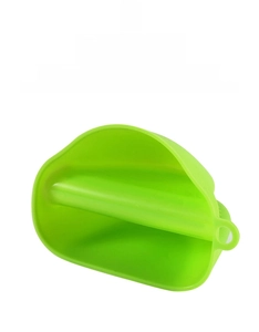 Close-up of bright green heat-resistant silicone oven mitt with a hanging hole design