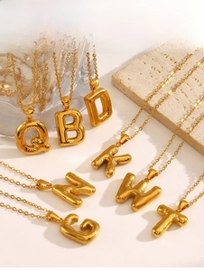 Detail of chubby 3D balloon-style gold letter pendants with a matching cable chain