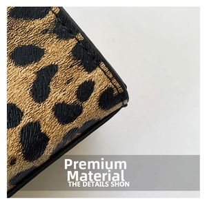 Close-up of leopard print faux leather texture with detailed stitching on crossbody bag