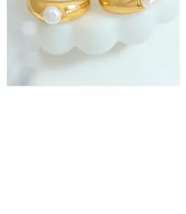 Detail of minimalist gold-plated chunky ring with a round white pearl inlay