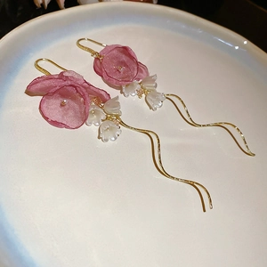 Detail of pink fabric flower earrings with long pearl tassels and lily of the valley beads