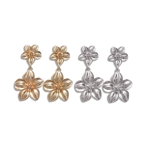 Metallic double flower drop earrings in gold and silver set on white background