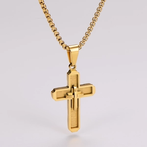 Detailed macro of gold stainless steel cross pendant with engraved Spanish prayer text