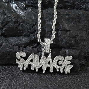 Macro shot of silver SAVAGE letter pendant with iced-out rhinestones on twist chain