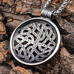 Vintage stainless steel Celtic hollow pendant with braided chain on rustic bark background
