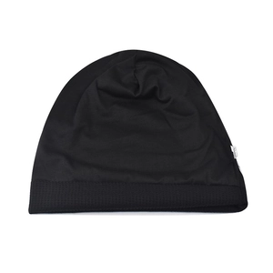 Close-up of black knitted beanie showing detailed honeycomb texture and woven side label