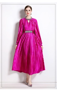 Detail of beaded fuchsia pleated dress showing crystal embellishments on neckline and waist