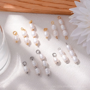 Detailed view of natural freshwater pearl pendants with gold and silver connector loops