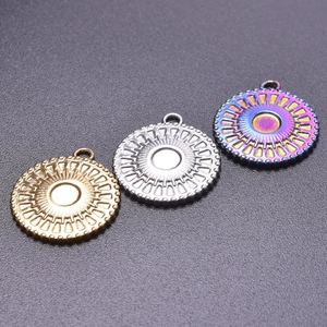 Detailed close-up of 18k gold, silver, and rainbow sunburst stainless steel charms