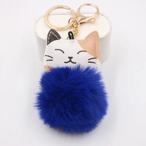 Detail of cute calico cat plush pompom keychain with golden metal ring and lobster clasp