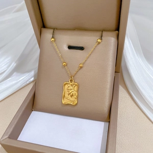 Gold rectangular sunflower pendant necklace with Vincent engraving in a jewelry box