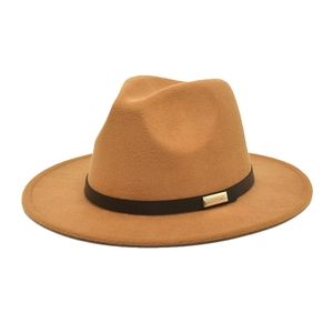 Detail of camel wool fedora hat with brown leather band and gold buckle accent