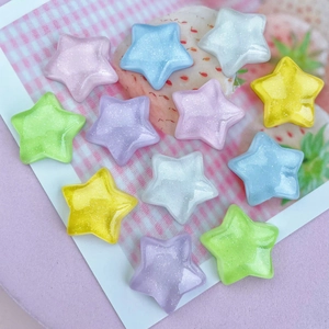 Close-up of glittery colorful star resin charms for DIY phone cases and hair clips