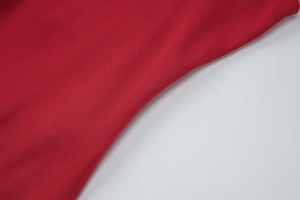 Vue macro détaillée de la texture du tissu en maille rouge de qualité pour robe moulante