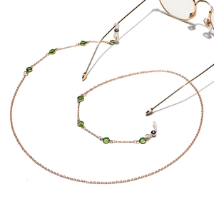 Elegant gold-plated eyewear chain featuring vibrant green round-cut crystal beads