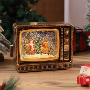 Detail of vintage TV musical box with Santa scene and swirling glitter snow effect
