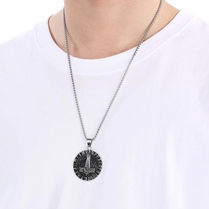 Silver Viking pendant featuring Thor's hammer and Nordic runes on a model