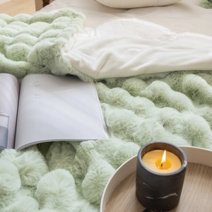 Detailed texture of mint green faux rabbit fur blanket with luxury bubble plush pattern