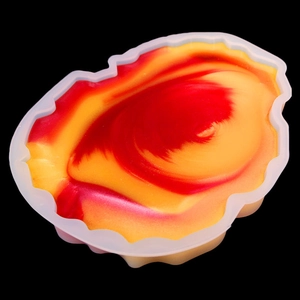Macro view of silicone mold with red and yellow epoxy resin creating agate texture