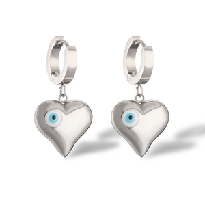 Detailed macro view of heart shaped silver earrings featuring blue evil eye enamel inlay