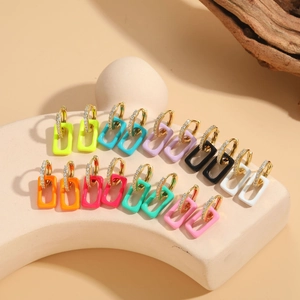 Close-up of nine pairs of colorful enamel geometric earrings with sparkling zircon inlay