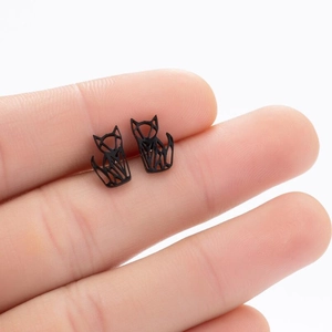 Minimalist black geometric fox stud earrings with matte finish shown on hand
