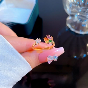 Elegant gold open ring featuring a colorful zircon flower and star on model hand