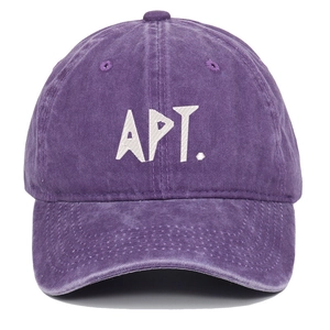 Detailed close-up of purple washed cotton baseball cap with white APT embroidery