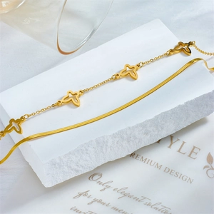 Gold double-layered anklet featuring a hollow butterfly charm and sleek snake chain link