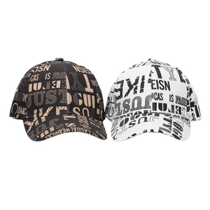 Detailed view of street style baseball caps with all-over typography graffiti prints