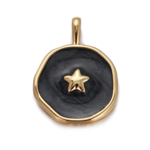 Detailed macro view of gold-plated celestial pendant with black enamel and gold star motif