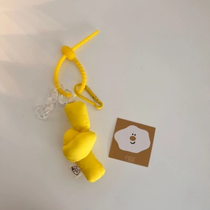 Detail of yellow plush knot keychain with spiral cord and transparent chain links