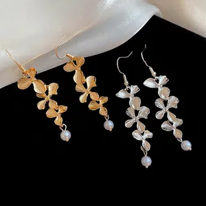Elegant gold and silver metal flower petal tassel earrings with white pearl pendants