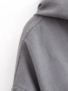 Detailed view of the dark grey drawstring hoodie shoulder and premium fabric texture