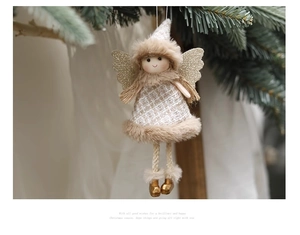 Detail of Christmas angel doll hanging on tree with golden wings and plaid dress
