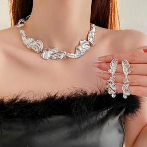 Modern silver irregular lava texture jewelry set with necklace and earrings on model