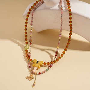Vintage layered beaded necklace with amber crystal facets and yellow butterfly pendant