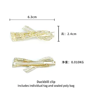 Golden bow hair clip with crystal rhinestones and metal duckbill grip shown in 6.3cm size