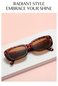 Detailed view of vintage tortoiseshell rectangle sunglasses on a soft pink geometric display