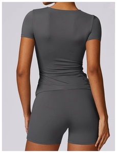 Rear view of tight-fit yoga set with dark grey short sleeve T-shirt and shorts