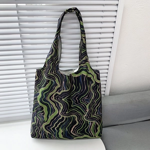 Detail of floral canvas tote bag showing soft fabric texture and colorful wave patterns