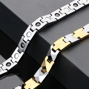 Detail shot of magnetic health bracelets in silver and gold-tone polished tungsten steel